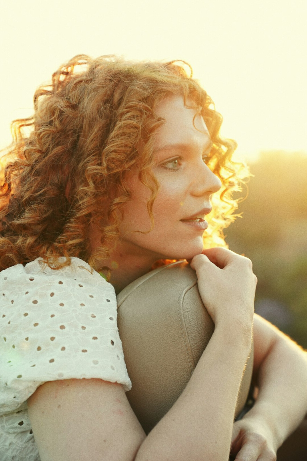 Portrait of a young woman with curly hair smiling